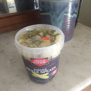 a container of pickles on a counter