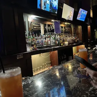 a man using a cell phone at a bar