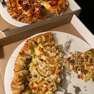 a half eaten pizza and a half eaten pizza