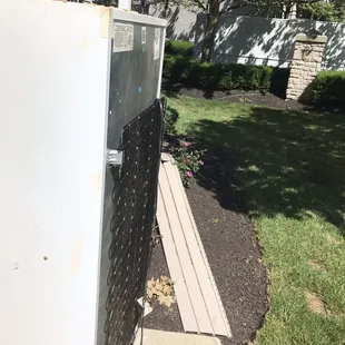 This refrigerator was moved three different times in 2 weeks, as well as the siding laying over the flowers.