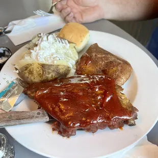 Rib and chicken special with potato, roll and salad.