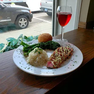 Sesame Crusted Ahi Tuna topped with Wasabi Aioli. Served with Coconut Rice, Green Beans (Not Pictured) and a Roll.