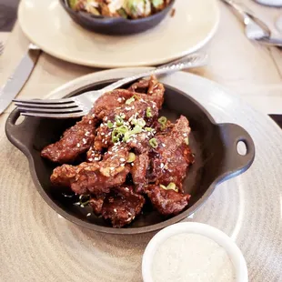 Steak bites with kalbi sauce, scallion cream and sesame