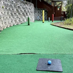 a blue ball on a green course