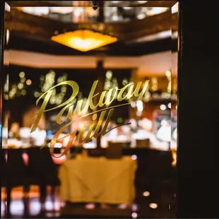 the reflection of the restaurant's sign