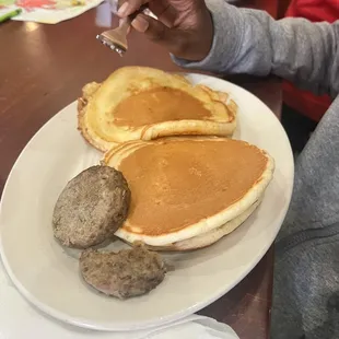 a plate of pancakes and sausages