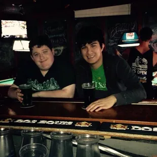 two men sitting at a bar