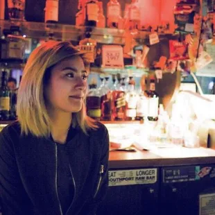 a woman sitting at a bar