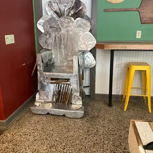 a metal sculpture of a man holding a knife