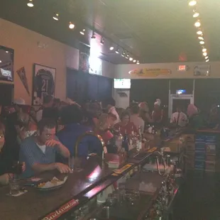 a large group of people sitting at a bar