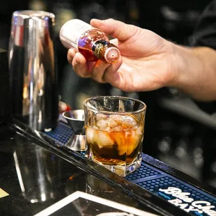 a bartender pouring a drink