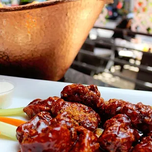 a plate of chicken wings and carrots