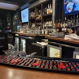 a bar with a bar counter and a television in the background