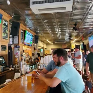 a group of people sitting at a bar