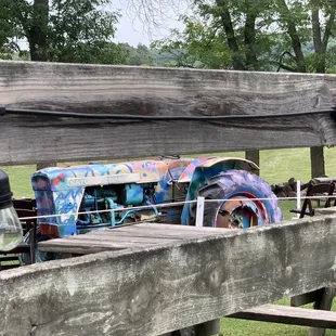 an old tractor on a wooden bridge