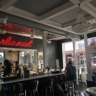 a view of a bar with people sitting at the bar