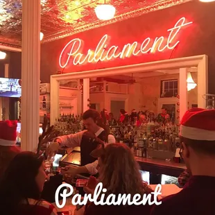 a group of people sitting at a bar