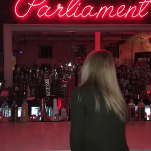 a woman standing in front of a bar