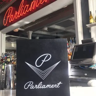 a sign in front of a bar