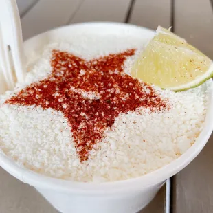a bowl of rice with a lime slice on top