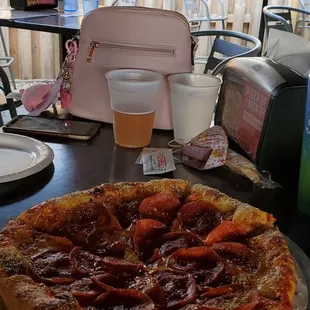 Eating outside, their pizza is the best.