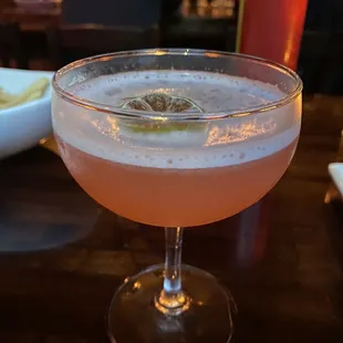 a close up of a drink in a coupe glass