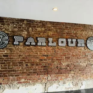 a brick wall with the word parlour on it