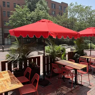 tables with red umbrellas