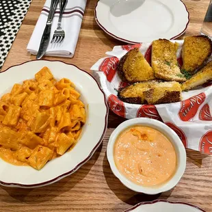a plate of pasta and a bowl of sauce
