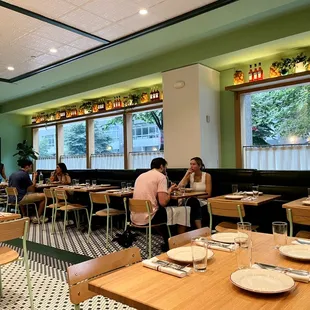 people sitting at tables in a restaurant