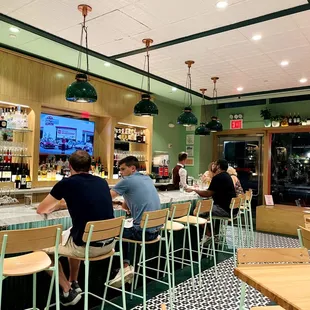 a group of people sitting at a bar