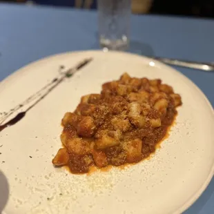 a plate of pasta and a glass of water