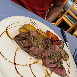 Steak w/ potatoes and grilled vegetables.