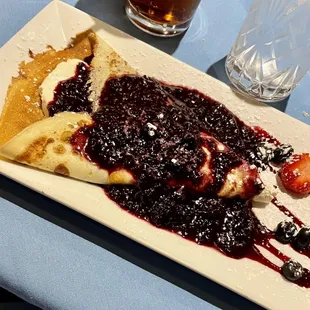 Crepe with citrus mascarpone and berry sauce