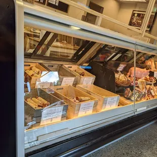 a display case with a variety of sausages