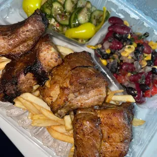 Baby back ribs with fries, cucumber salad, beans salad