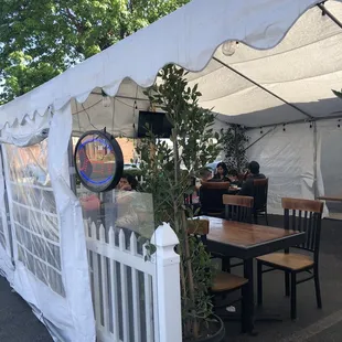a table and chairs under a tent