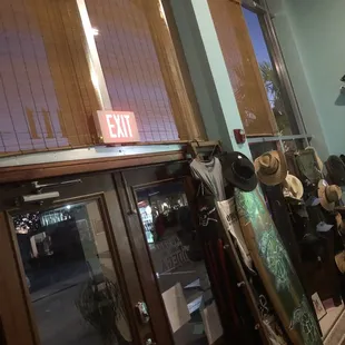 The doorway from the interior with cool paddleboard&apos;s and hats