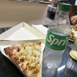 Slice of Hawaiian pizza plus a bottled soft drink for scale reference (I did already take one bite into my pizza LOL)