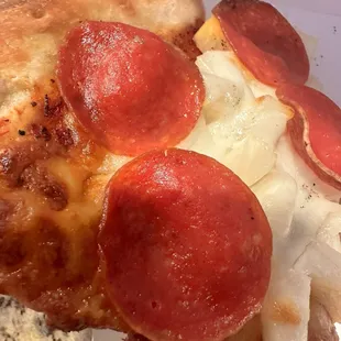 Old layer of cheese (dark) under new layer of cheese(lighter colored layer)/pepperoni/pineapple