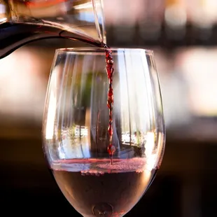 a glass of wine being poured