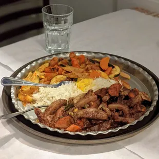 Vegetarian dinner for two: a platter of grilled veggies in Mediterranean tomato sauce and pomegranate walnut sauce, served with rice