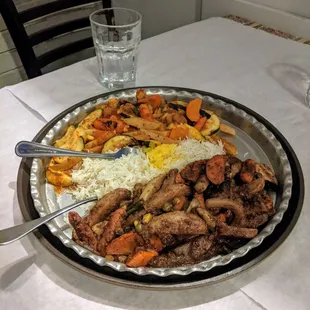 Vegetarian dinner for two with two types of grilled vegetables in different sauces and rice. This is a large platter.