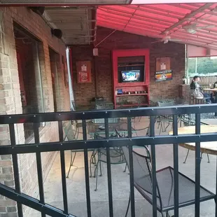 a patio with tables and chairs