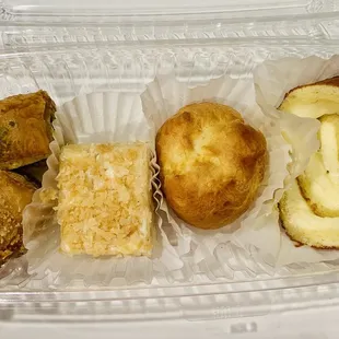 a variety of pastries in a plastic container