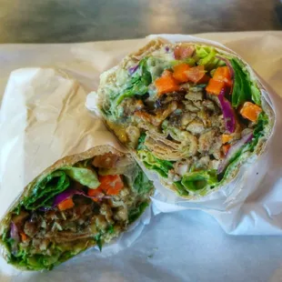 Large Chicken Wrap with spicy carrots inside and green hot sauce. Delicious