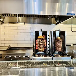 two kebabs being cooked in a commercial kitchen