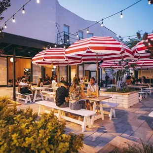 a patio with tables and umbrellas