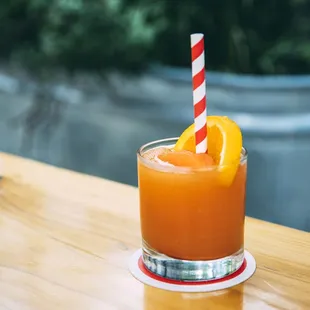 a glass of orange juice on a table