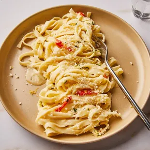 a plate of pasta and a bowl of rice